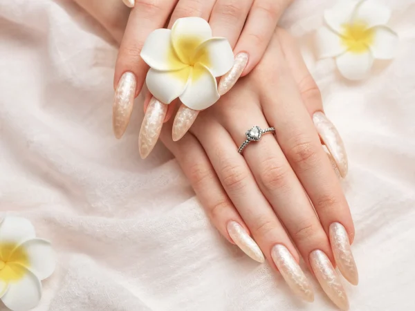 hand-young-woman-with-white-pearl-manicure_7_11zon